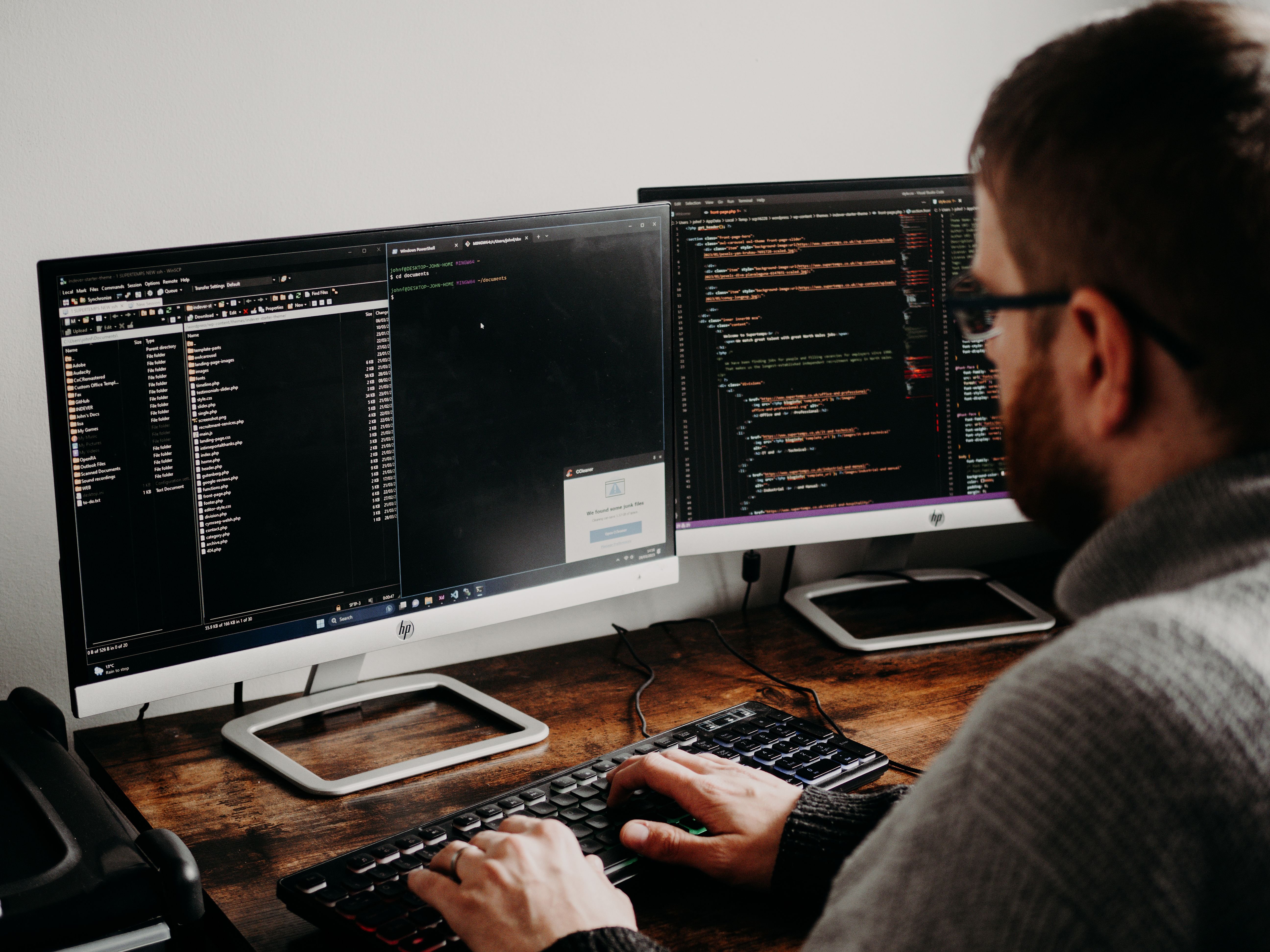 Man facing a monitor typing on the keyboard